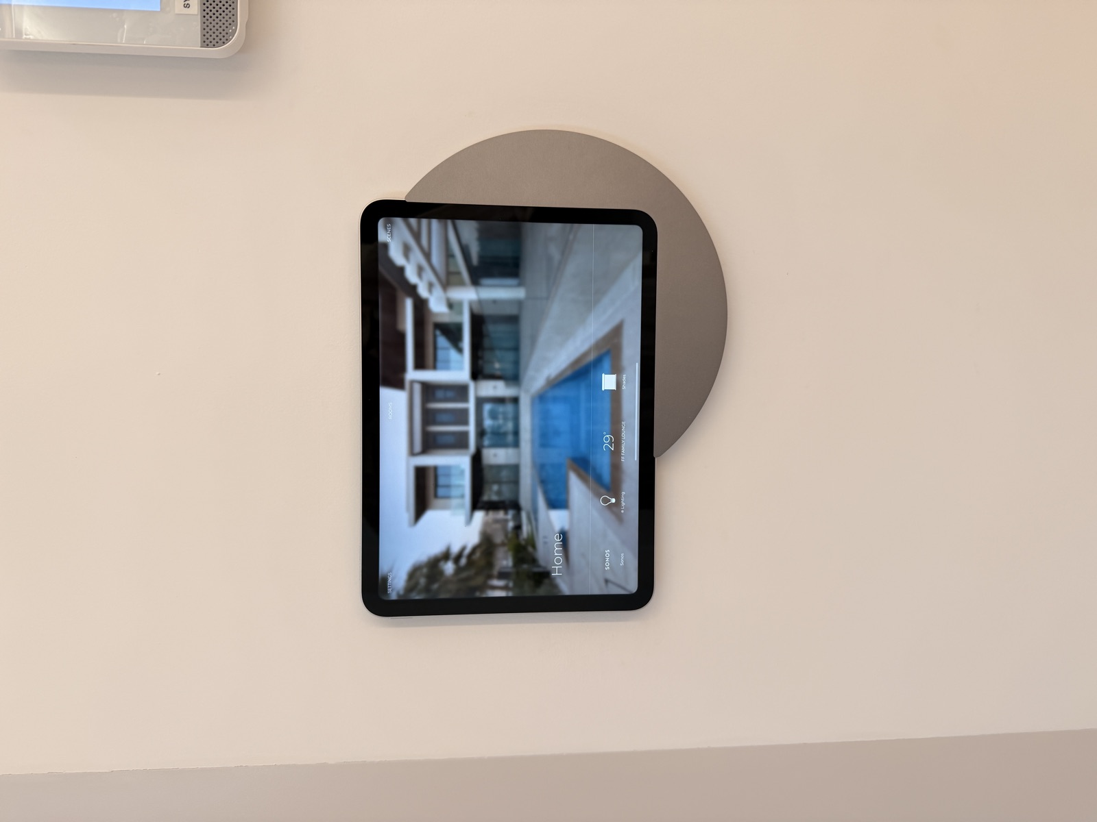 A home touchscreen with Sonos, lighting, climate and shading options.