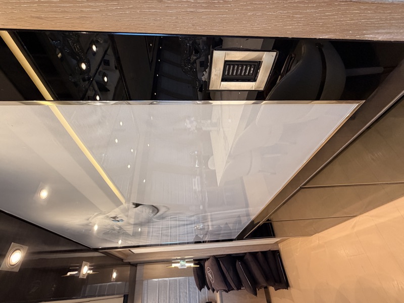 A wall-mounted lighting keypad integrated into a reflective interior finish.